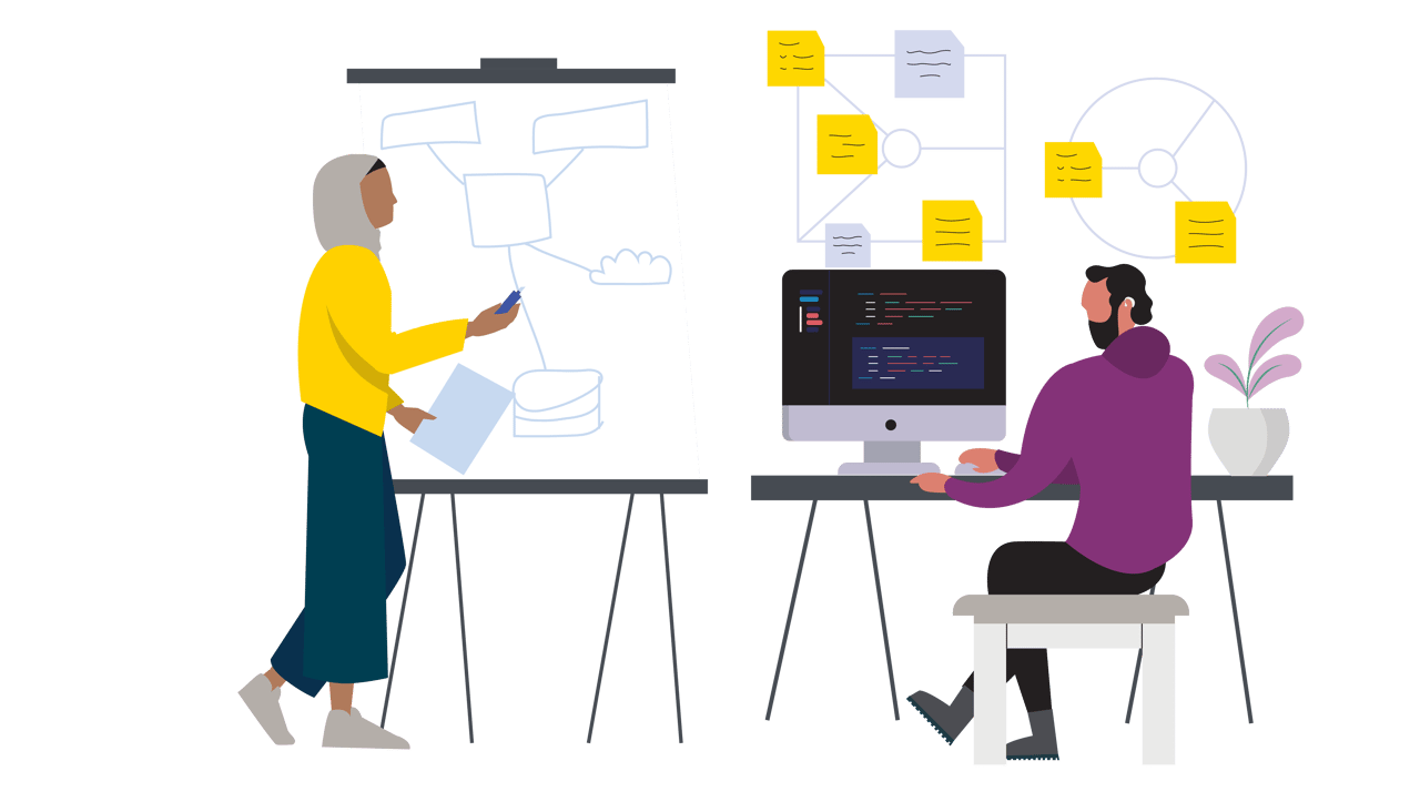 A woman draws a system on a flipchart while a man works on a computer
