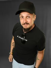 A picture of Janne Toivonen, a Senior Atlassian Consultant at Eficode, wearing a black cap and t-shirt with Atlassian logo in the front.