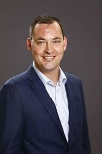 Stefan Van den Steen, Sales Director at Lansweeper, wearing a navy blue suit.