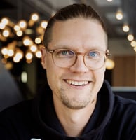 A picture of Marko Klemetti, the CTO of Eficode, smiling while wearing a black hoodie and eyeglasses.