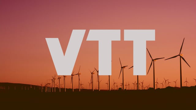 A gray VTT logo with an image of wind turbines in sunset on the background.