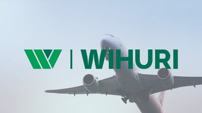 A green Wihuri logo with a background image of a plane.