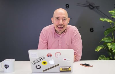 Eficode's employee Mikko Drocan sitting by the desk and the computer