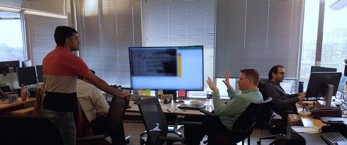 Three men discussing in an office room
