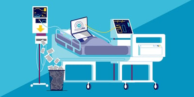 A laptop on a hospital bed connected to machines