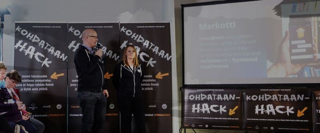 two people standing and watching the screen in Hackhaton event