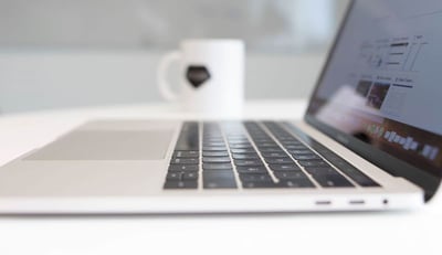 open laptop and a mug on the table