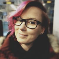Maija Poppanen, a Senior Consultant at Eficode, with pink hair and black eyeglasses.