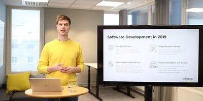 Man standing beside a white board with text software development in 2019