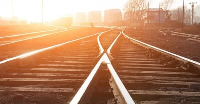 Two railroad tracks meet and continue as one track