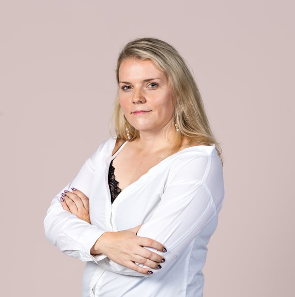 An image of Tiina Koivula, Head of Support Services at Accountor HR Solutions in a white shirt against a taupe background.